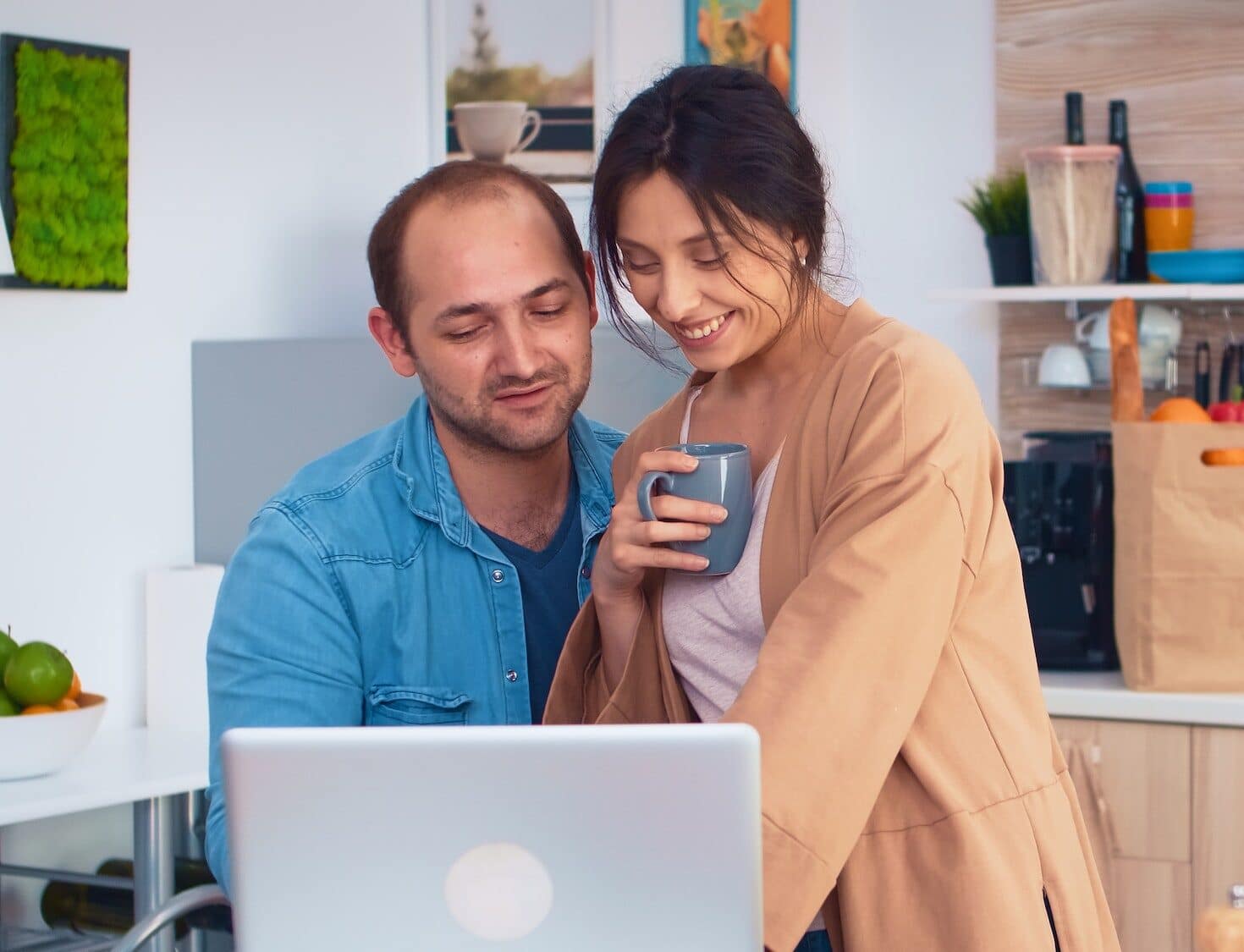 Happy entrepreneur couple working on laptop